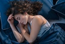 3 grunde til, at det er en dårlig idé at sove ved siden af sin telefon En pige sover i sin seng