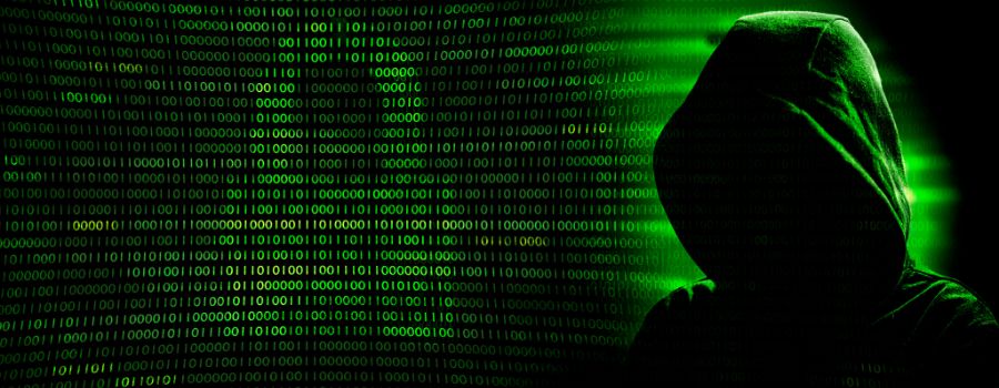 6 måder, hvorpå du kan miste dine penge ved at bruge kryptobørser, og hvordan du undgår dem 1 Hackerens silhuet på en mørkegrøn, digital baggrund