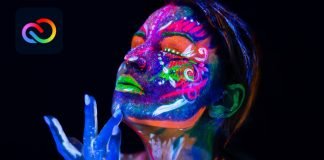 Kvinde med neonlys malet på ansigtet og hænderne på en sort baggrund, med Adobe Creative Cloud logo i øverste venstre hjørne.
