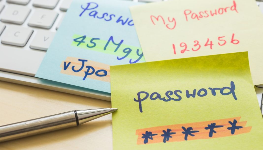 Et billede, der illustrerer en usikker måde at opbevare passwords på. Farverige post-it sedler med håndskrevne passwords ligger spredt ud på et computertastatur.