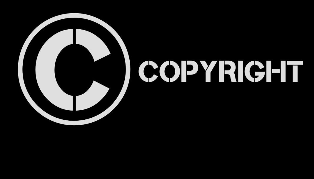 Et billede af et cirkelformet copyright-symbol med ordet "copyright" skrevet ud.