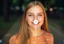 En ung kvinde står på en sti i en park. Hun har langt, rødt hår og er klædt i en orange bluse med hvide prikker og et rævemotiv.