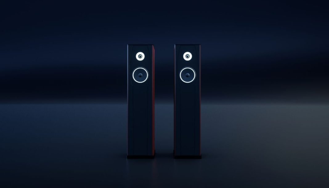 hi-fi To sorte, slanke hi-fi-højttalere med hvide ringe omkring enhederne står side om side i et mørkt rum.